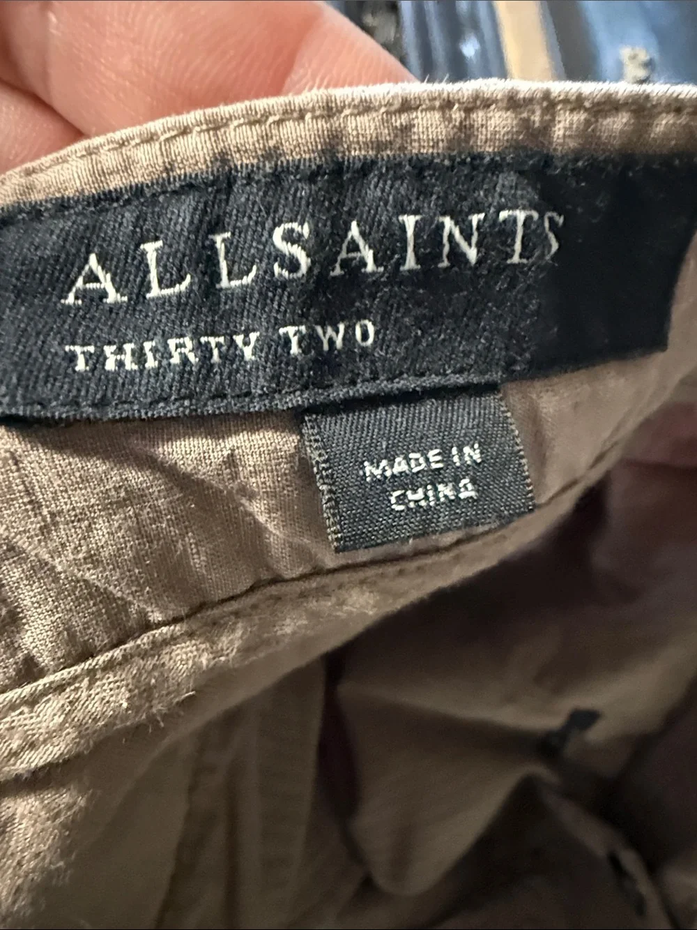 AllSaints trousers with a pleated front and a button closure